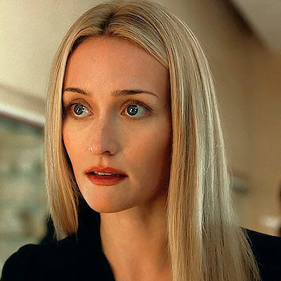 Woman with blonde hair and blue eyes looking off to the side.