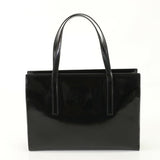 Black handbag with glossy finish on a white background