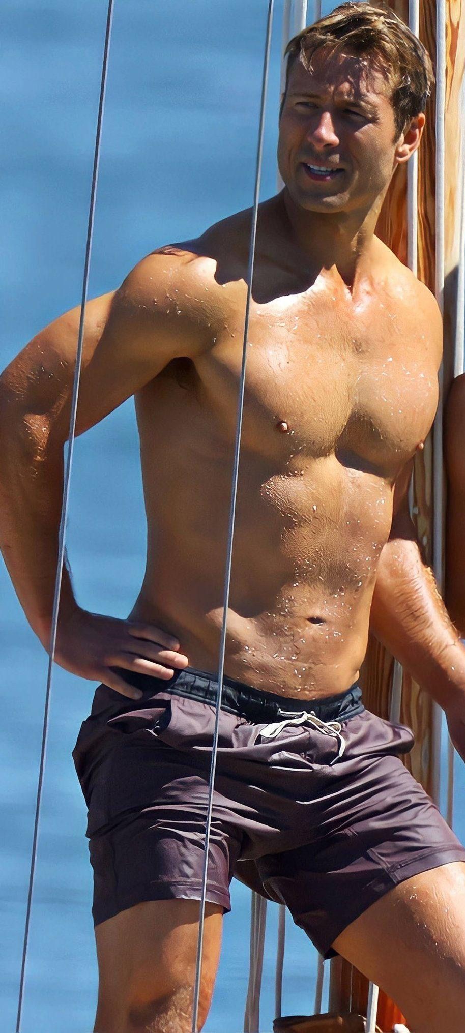 Man wearing dark shorts on a boat with a clear blue sky background