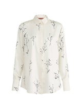 An off-white long-sleeve button-up shirt with a black botanical branch print, displayed on a clean white background.