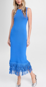 Woman wearing a blue dress with fringe details on a white background