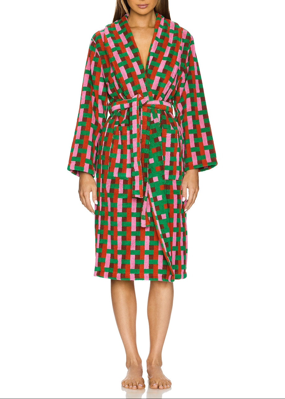 Woman wearing a colorful checkered robe on a white background