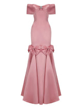 Pink off-shoulder gown with bow details on a white background