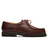 Brown leather shoe with a brand label on a white background