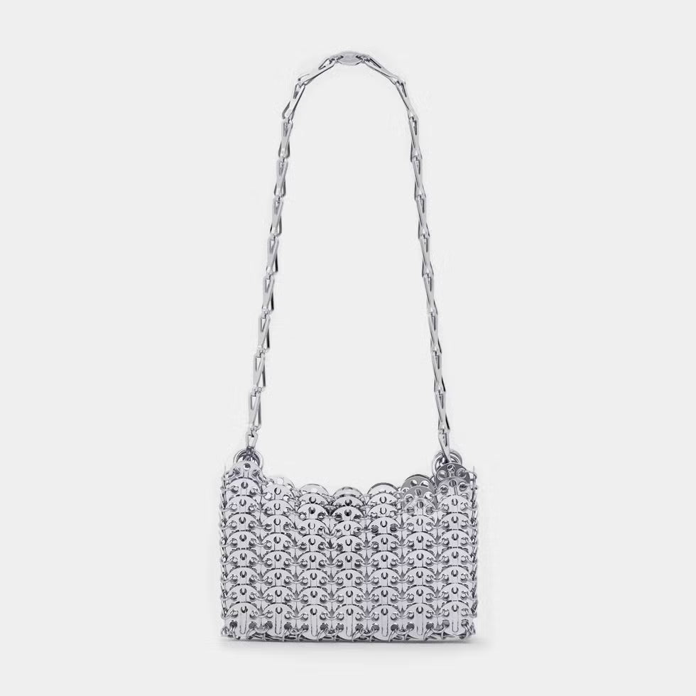 Silver beaded handbag with a chain strap on a light gray background