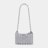 Silver beaded handbag with a chain strap on a light gray background