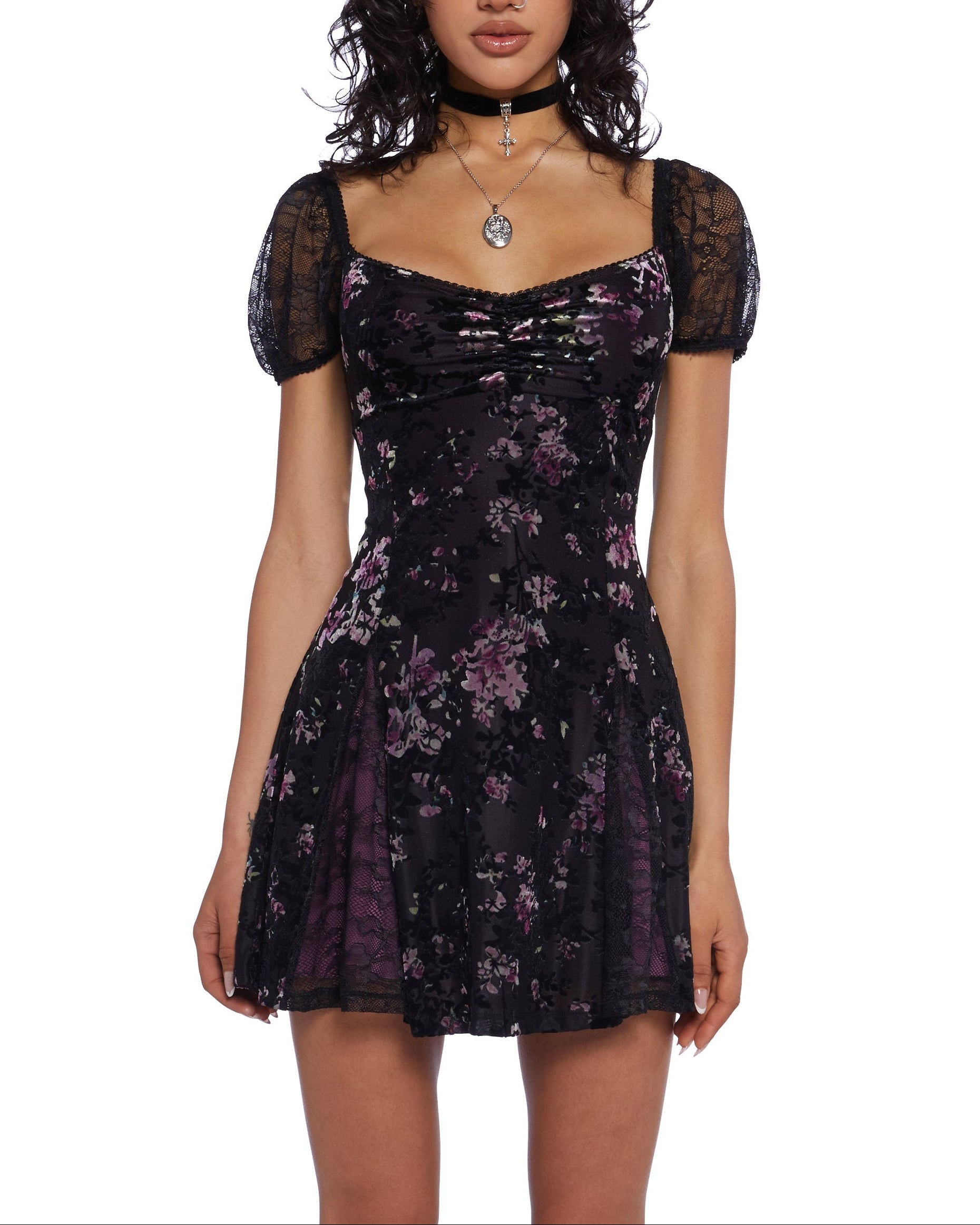 Woman wearing a black floral dress on a white background