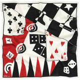 A square scarf featuring a bold retro game-inspired design with black and white checkers, red backtick triangles, playing cards, dice, and club and heart suits. The brand name 'MARKE' is visible in the bottom-left corner.