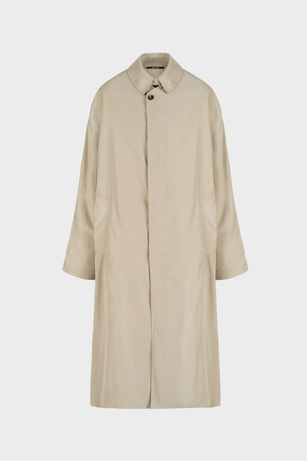 A light beige trench coat with a single button closure, collar, and front pockets, shown against a plain light gray background.